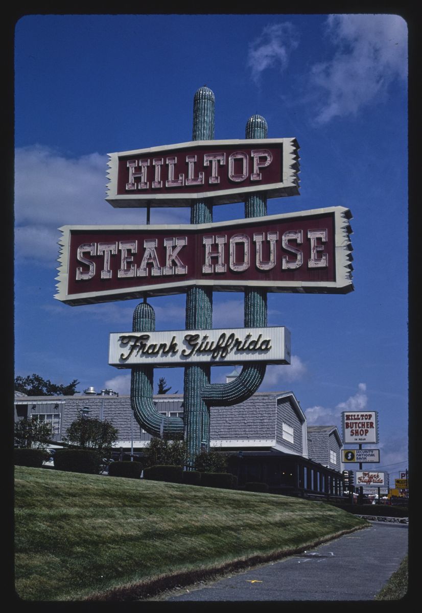 The Hilltop Steak House sign with Frank Giuffrida's signature and the neon cactus behind it