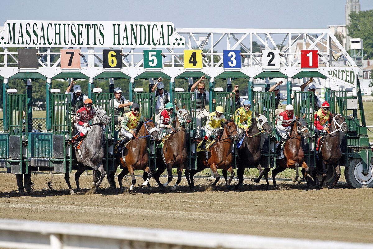 Horses breaking from the starting gate under the Massachusetts Handicap banner